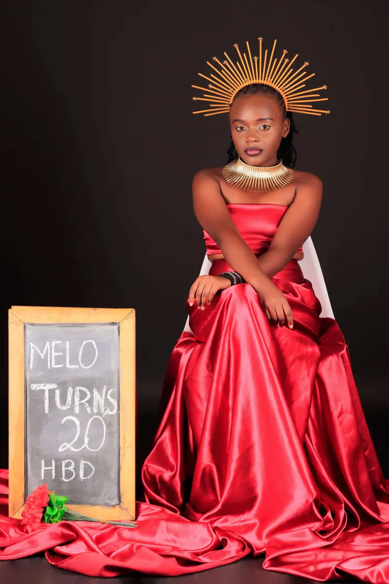 Studio birthday portrait of a young woman in a red satin gown